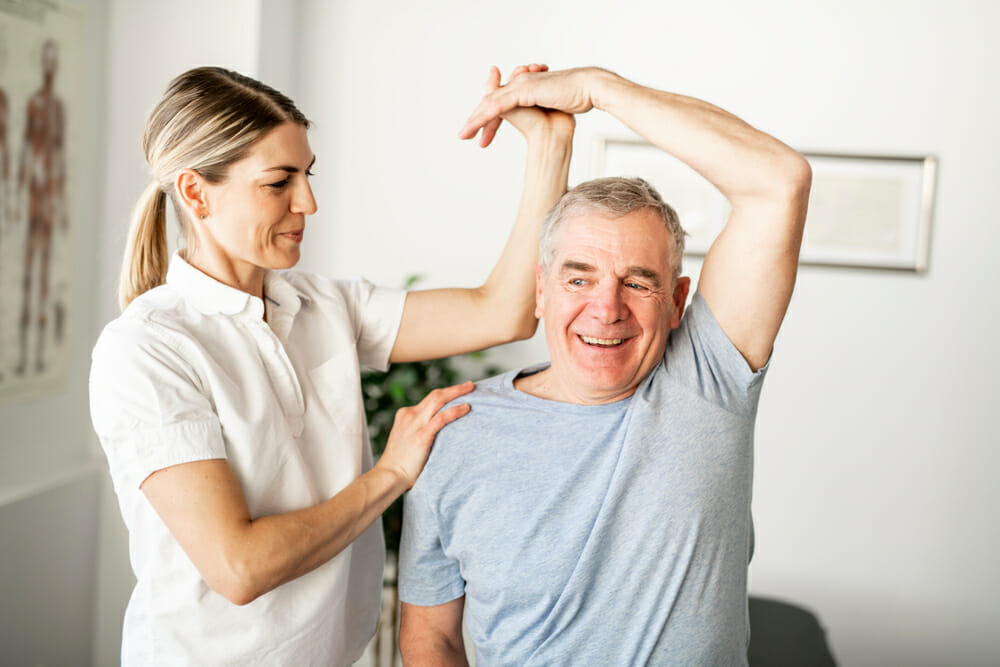 Physiotherapist treating shoulder pain