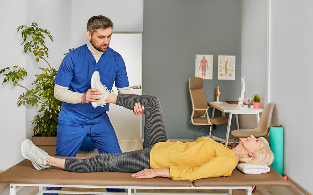 Physiotherapist treating elderly patient