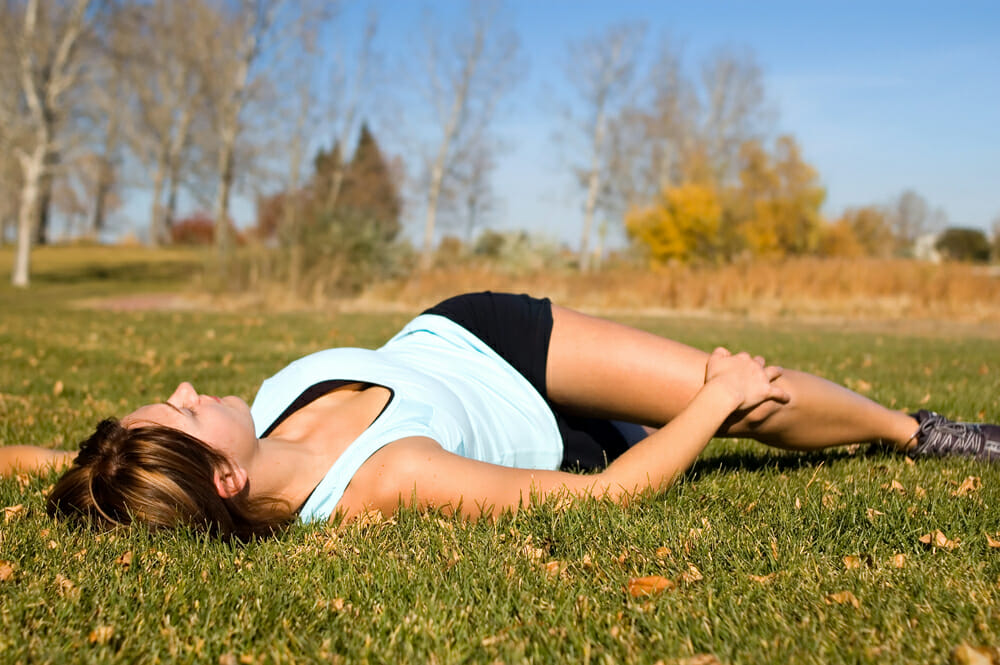 woman stretching her lower back