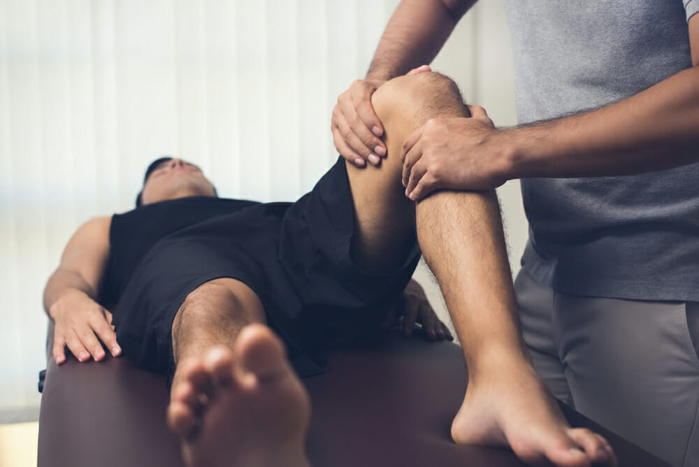Physio treating patient with knee pain