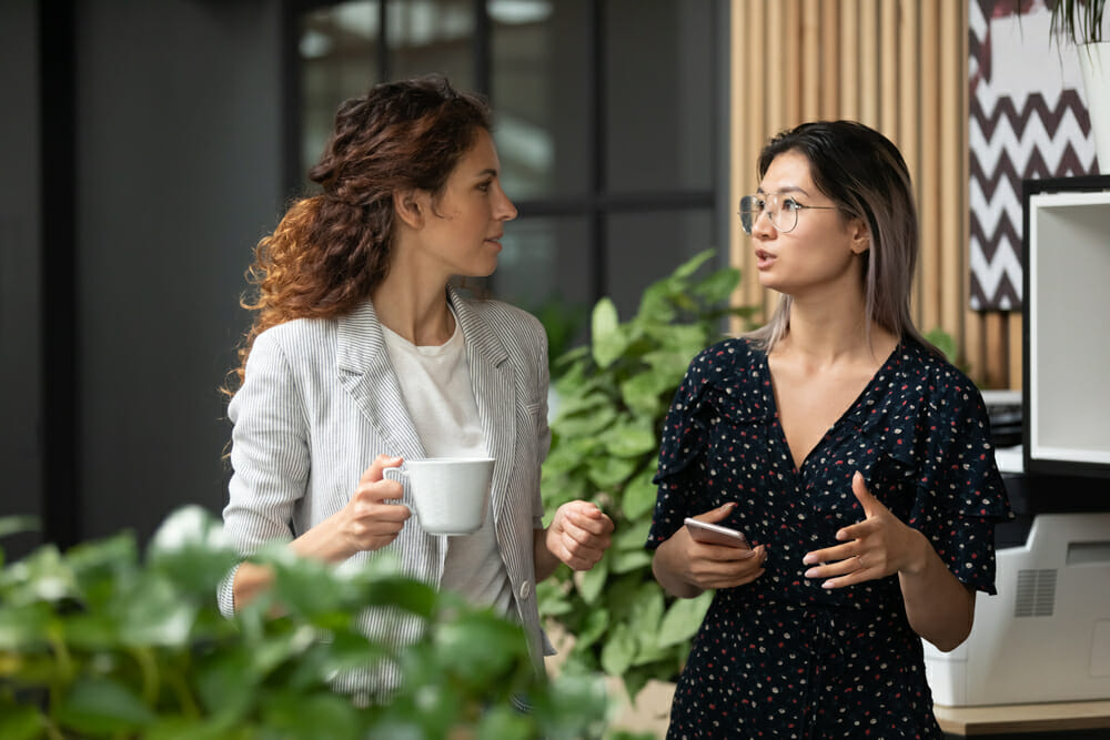 Office workers talking over coffee