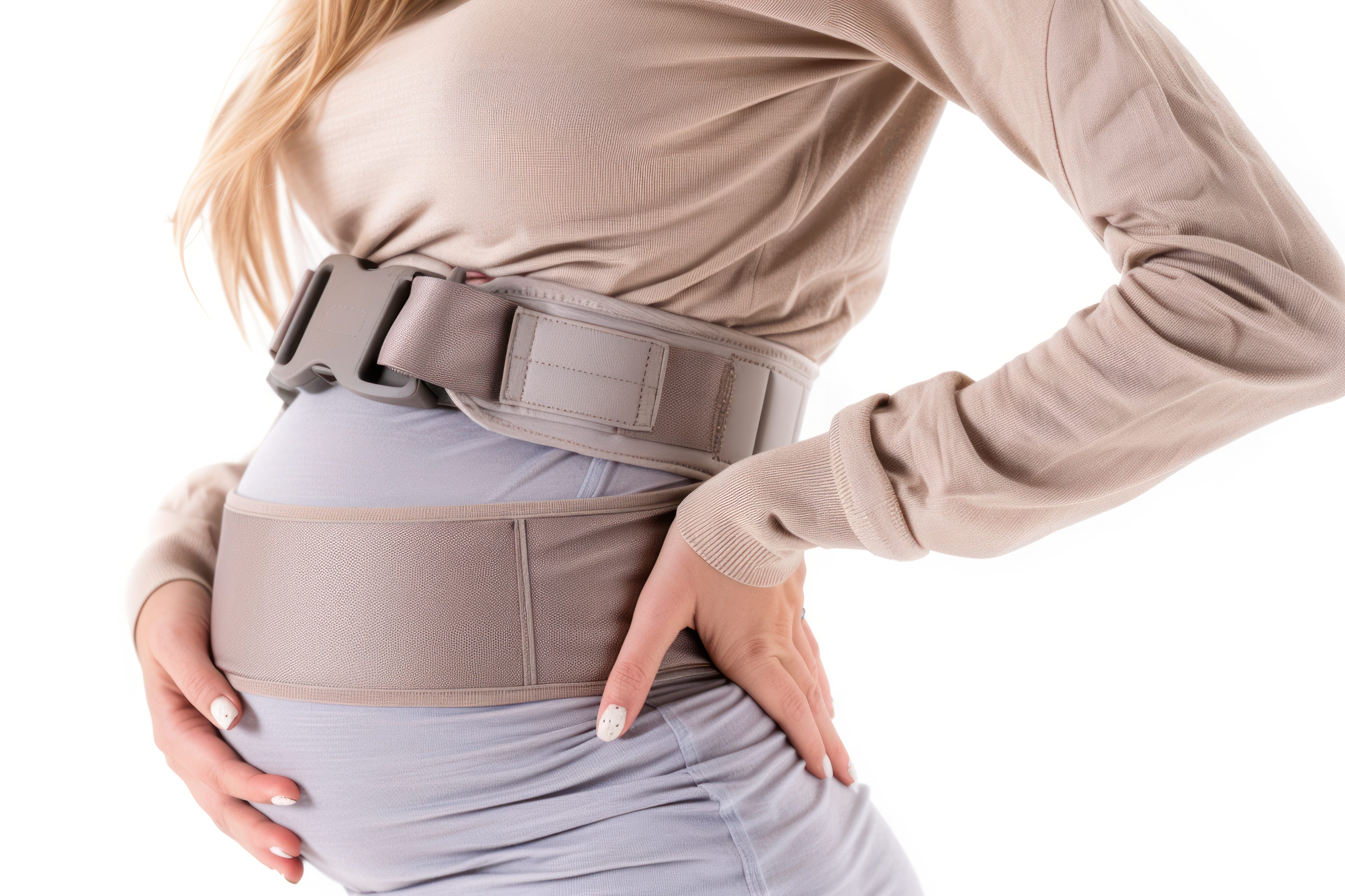 A pregnant woman wearing a maternity support belt close up.